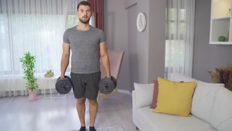 Strong-athletic-fit-man-in-t-shirt-and-shorts-exercising-at-home.